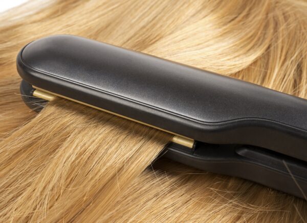 Straightening long blond hair with hair irons
